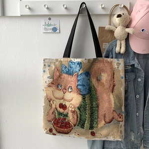 Detail of canvas tote bag featuring vintage cat illustration and sturdy black strap