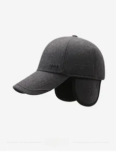 Detail view of winter baseball cap with ear flaps and premium metal logo decoration