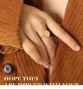 Detailed view of an 18k gold-plated titanium ring with an engraved Fu character