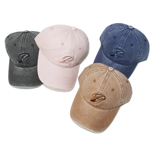 Detailed view of four washed cotton baseball caps in gray, pink, blue, and khaki