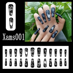 Detail of matte Christmas press-on nails featuring reindeer and snowflake patterns