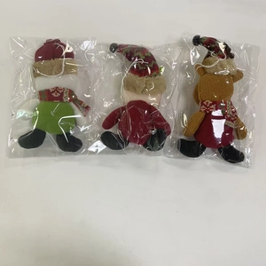 Detailed back view of plush Christmas tree hanging ornaments in clear packaging