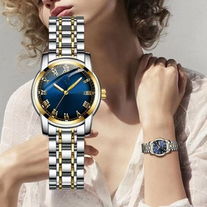 Detail of blue sunray dial quartz watch with Roman numerals and dual date display