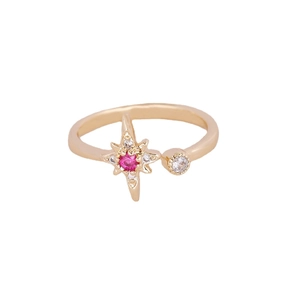 Golden star ring with red gemstone and white zircon accents on a clean white background
