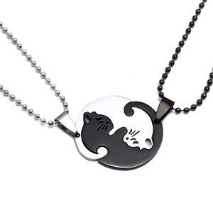 Close-up of titanium steel cat pendant set showing black and white yin yang design