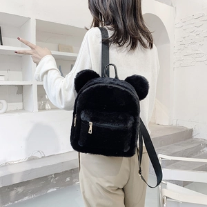 Women's black plush backpack with cute bear ears and golden zippers shown on model