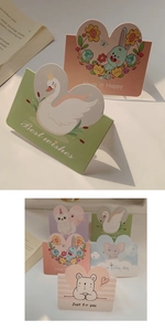 Detail of assorted cartoon animal greeting cards including rabbit and unicorn designs