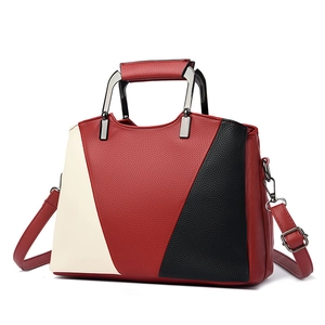 Minimalist tri-color leather tote bag with red, white, and black geometric patterns