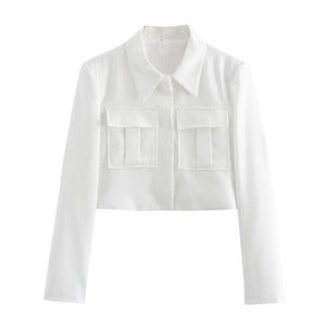 Detail of white cropped jacket featuring large lapels and symmetrical cargo pockets