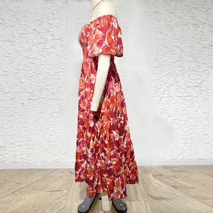 Side view of floral maxi dress with puff sleeves and tiered skirt for summer vacation