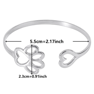 Detail shot of open silver cuff bracelet showing 5.5cm inner diameter and heart claw charm