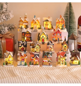Detailed group display of 16 mini lighted Christmas village houses with warm LED glow