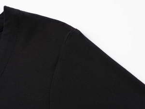 Detailed close-up of shoulder seam and V-neck stitching on black slim fit cotton t-shirt