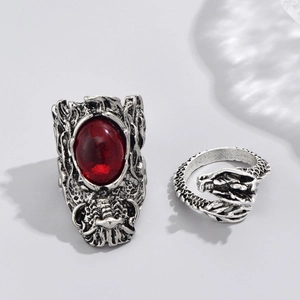 Gothic dragon ring set with red gemstone and wrap-around silver skull evil eye rings