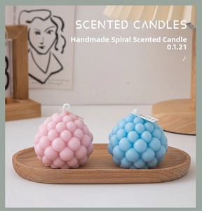 Pink and blue bubble scented candles set on a wooden tray with a warm home decor background