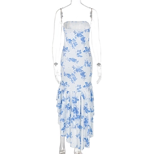Detail of white floral dress showing ruffle hem and blue flower print texture
