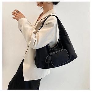 Detail of black nylon hobo bag with a matching detachable mini coin purse pendant