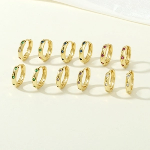 Detailed array of golden huggie earrings with colorful inlaid zircon gemstones