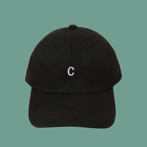 Close-up of the white embroidered letter C on a premium black cotton baseball cap