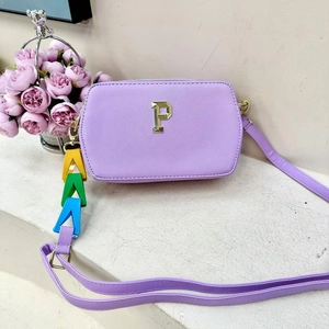 Purple leather crossbody bag with gold P logo and colorful PKK alphabet charm