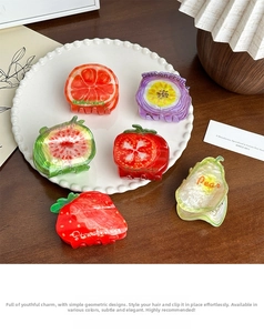 Detail of fruit-shaped acetate hair claws including strawberry and tomato designs