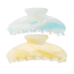Close-up of large marble acrylic hair claws with glitter finish for women's hairstyling