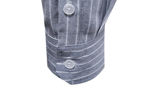 Detailed macro view of gray striped cotton shirt cuffs with polished buttons and texture