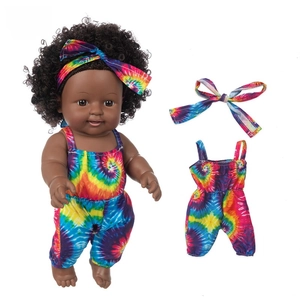 Detail view of 12-inch African doll in rainbow tie-dye romper with matching headband
