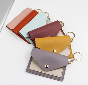 Flat lay of colorful PU leather card holders with snap buttons and gold keyrings