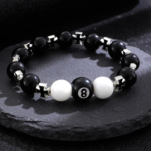 Macro detail of billiard 8 ball resin beaded keychain with silver cross spacer charms