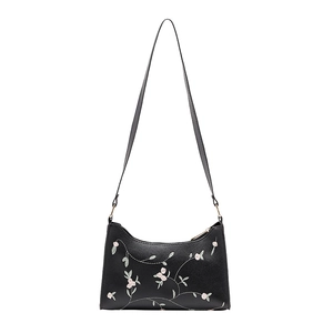 Elegant black shoulder bag with floral embroidery and gold hardware on white background