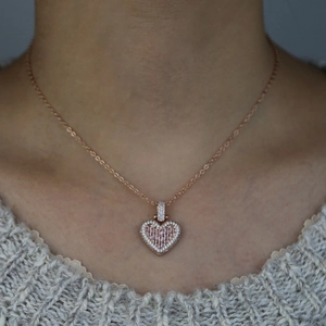 Hip hop rose gold heart necklace with pink zircon pendant worn on a female model