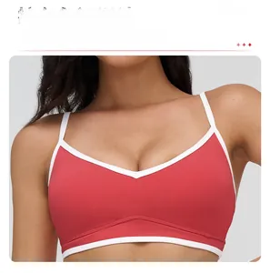 Detailed close-up of a red sports bra with white contrast piping and skinny V-straps