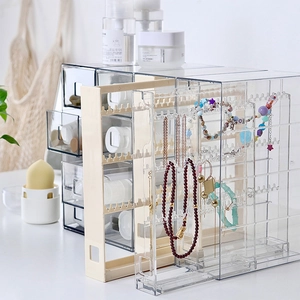 Transparent acrylic and beige jewelry organizer with drawers for necklaces and earrings