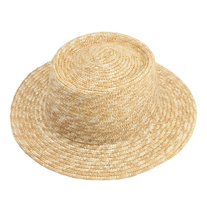 Handwoven straw boater hat for summer sun protection with wide flat brim and natural texture