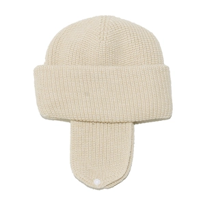 Detail of cream knit earflap hat with thick textured yarn and white chin snap button