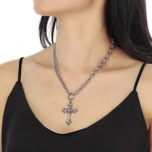 Detail of vintage cross pendant necklace with mixed link chain and OT buckle on model