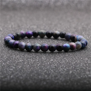 Macro detail of natural tiger eye stone bracelet with purple and blue shifting colors