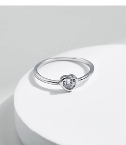 Close-up of minimalist heart-shaped moissanite ring on s925 silver band detail view