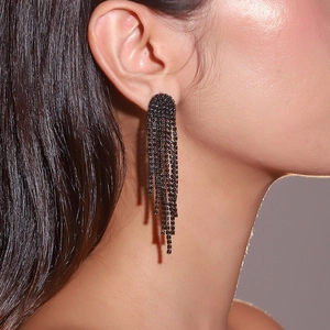 Close-up of elegant long black rhinestone tassel earrings worn on a model's ear