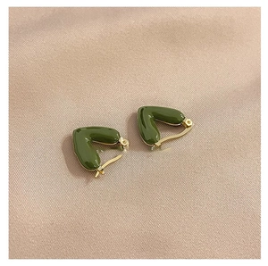 Elegant olive green V-shaped enamel hoop earrings with gold plating on silk background