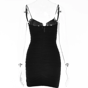 Detailed back view of a black mini dress featuring a ruched bodycon design and hidden zipper