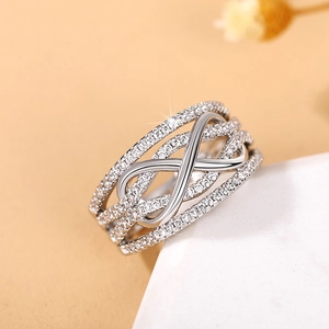 Detail of infinity symbol ring with silver plating and pavé white cubic zirconia stones