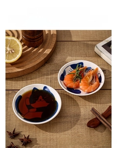 Macro view of Japanese style ceramic cat sauce dish on a rustic wooden table setting