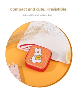 Detail of square orange cartoon rabbit coin purse with red zipper and hand strap