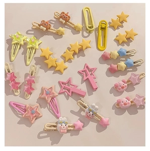 Flat lay view of colorful Y2K star and cartoon animal hair clips on a beige background