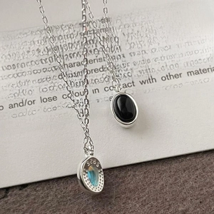 Macro detail of S925 sterling silver necklaces with black stone and blue fire labradorite