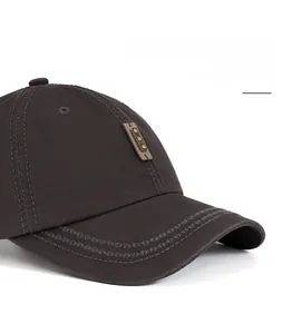 Close-up of washed cotton baseball cap with curved brim and leather logo detail