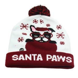Detail of knitted Christmas hat featuring Santa Paws bulldog and LED light control button