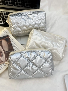Quilted heart pattern makeup bags in silver and white colors for versatile storage